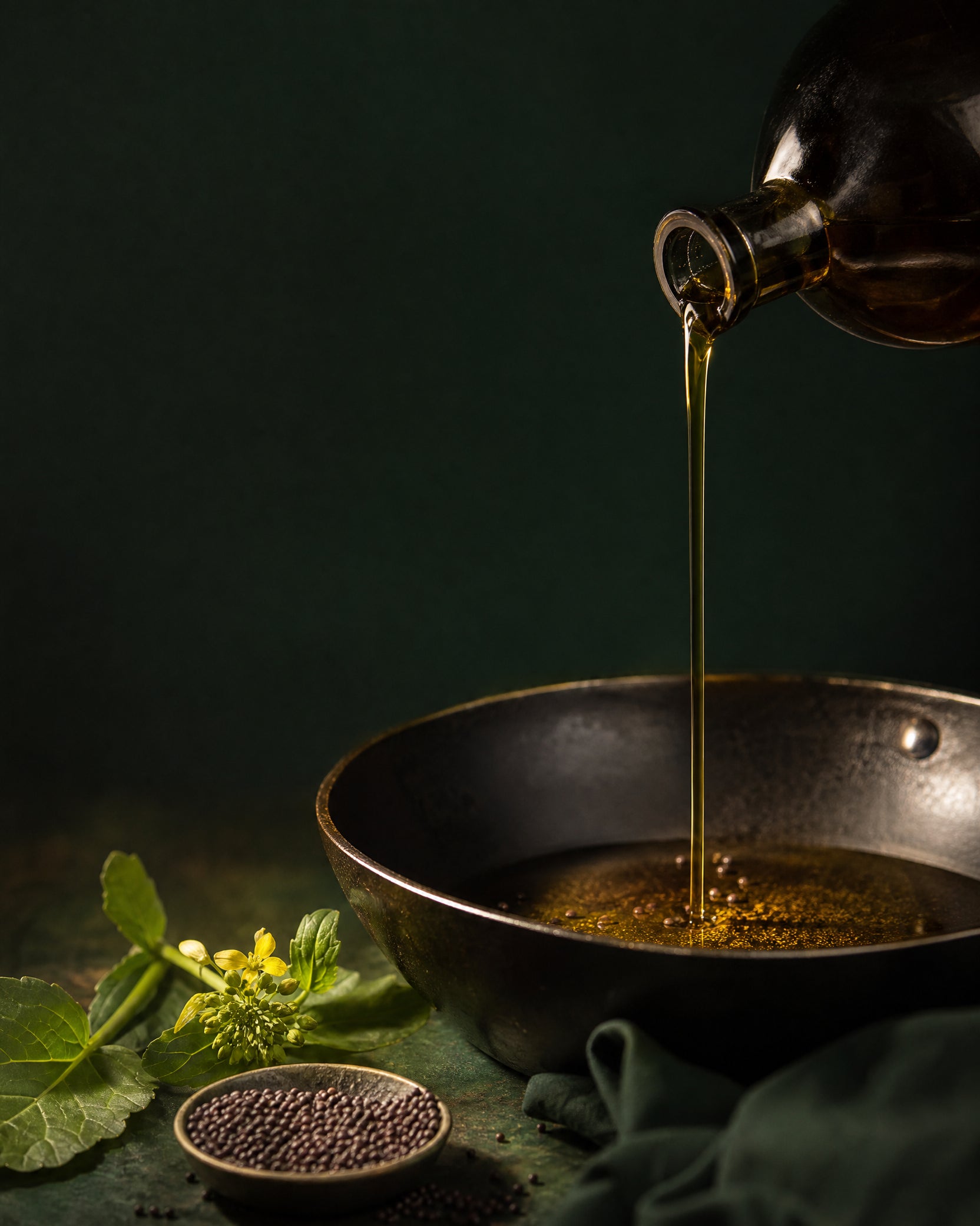 Oil pouring into a traditional cooking pan
